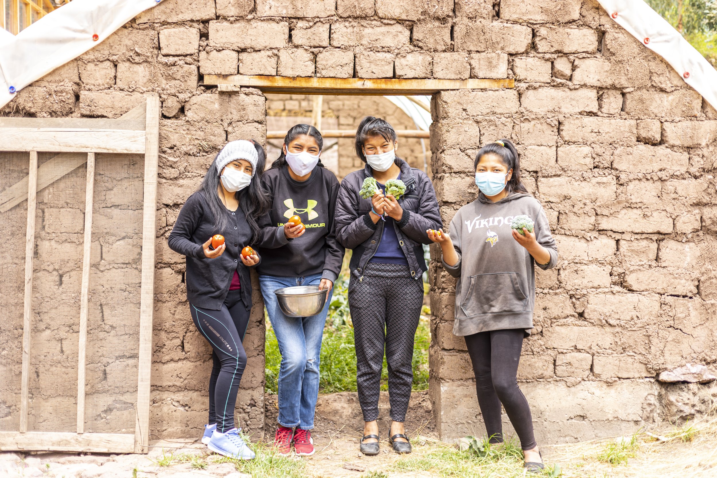 four girls standing outside the garden at the Sacred Valley Project in Peru.jpg