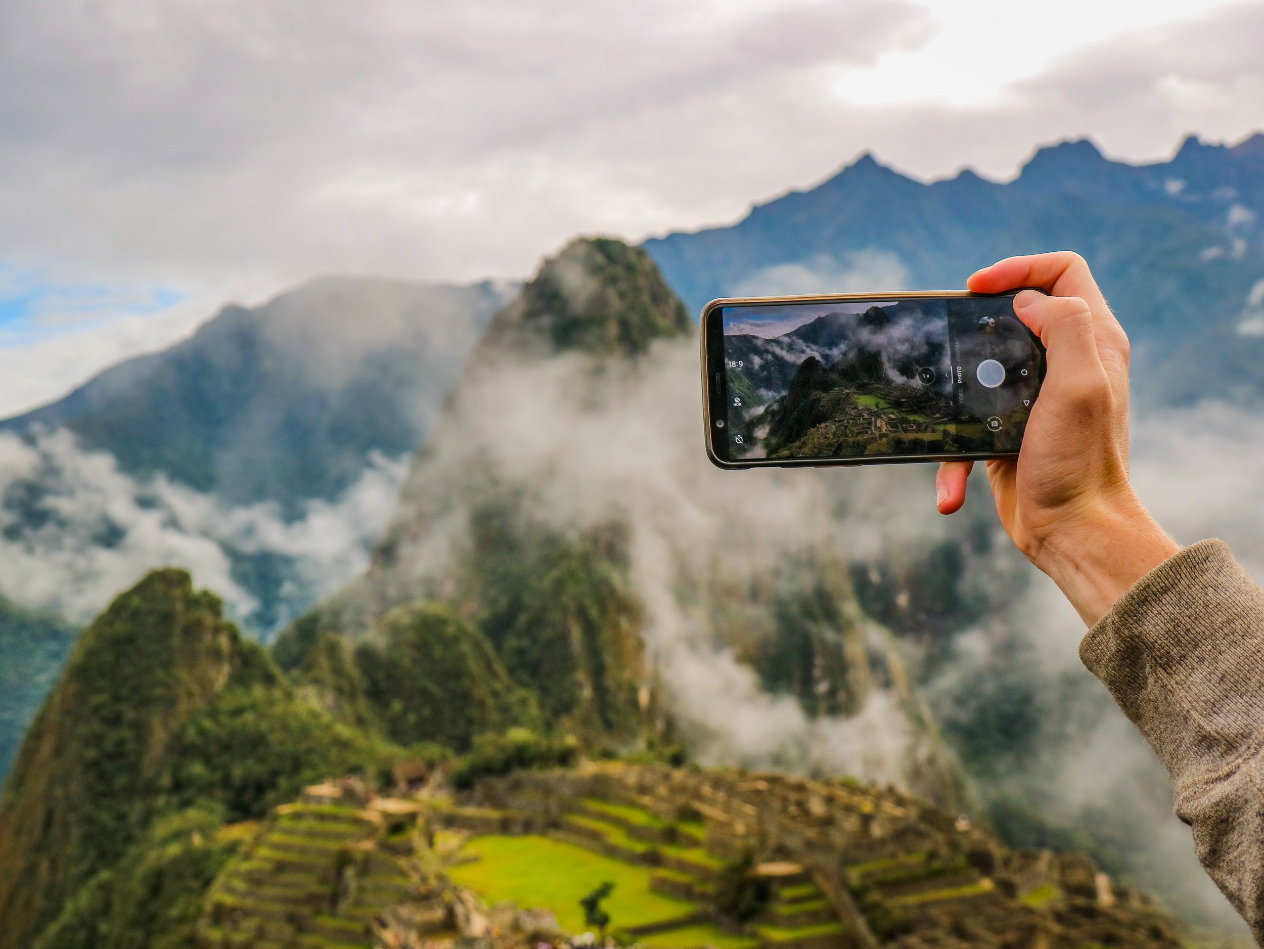 person taking an iphone photo of Machu Picchu in Peru.jpg