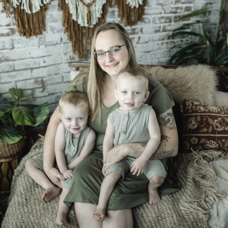 Ashley Norris, holding her identical twin boys