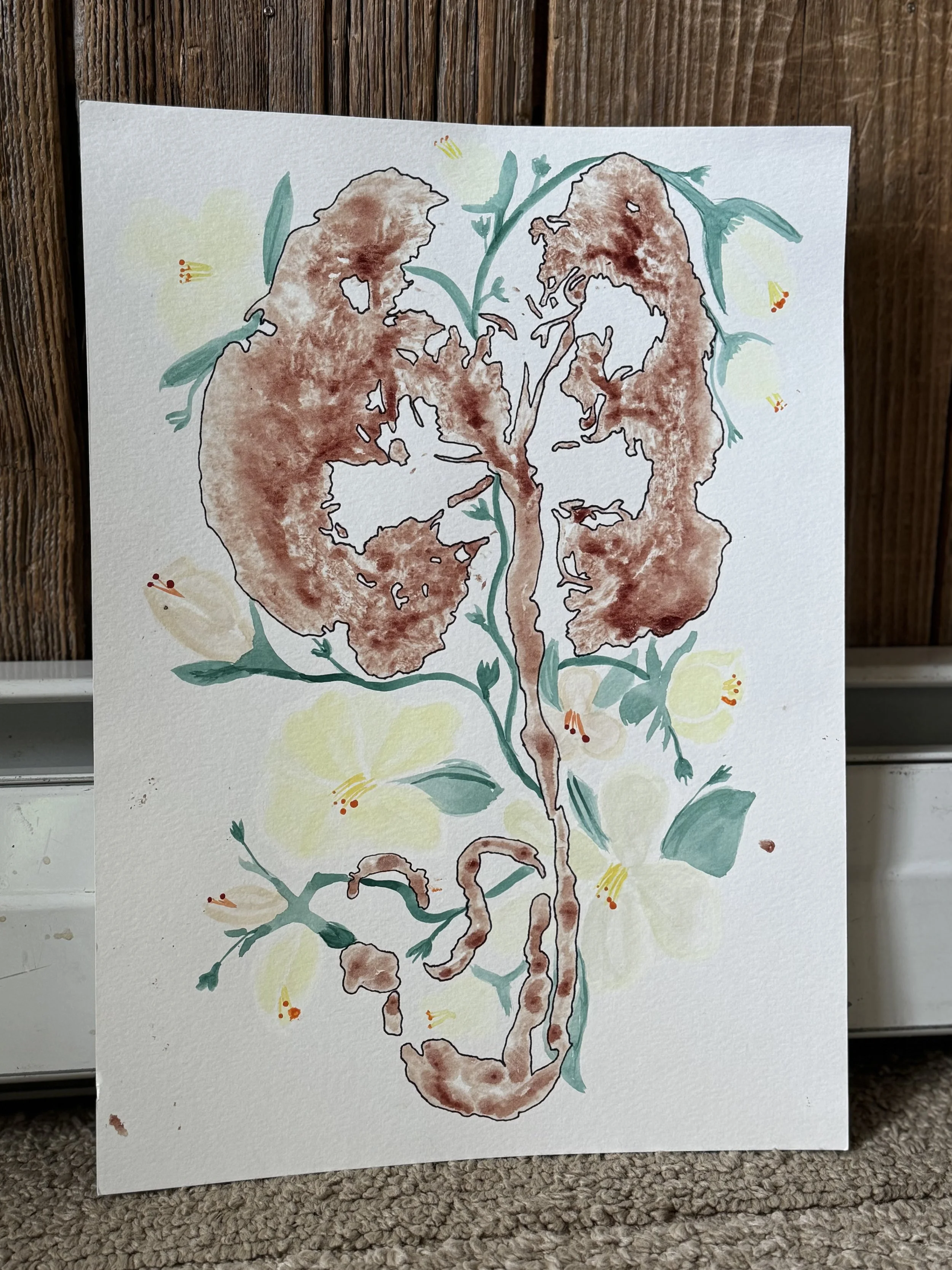 Watercolor painting of a human brain with floral and vine patterns intertwined.