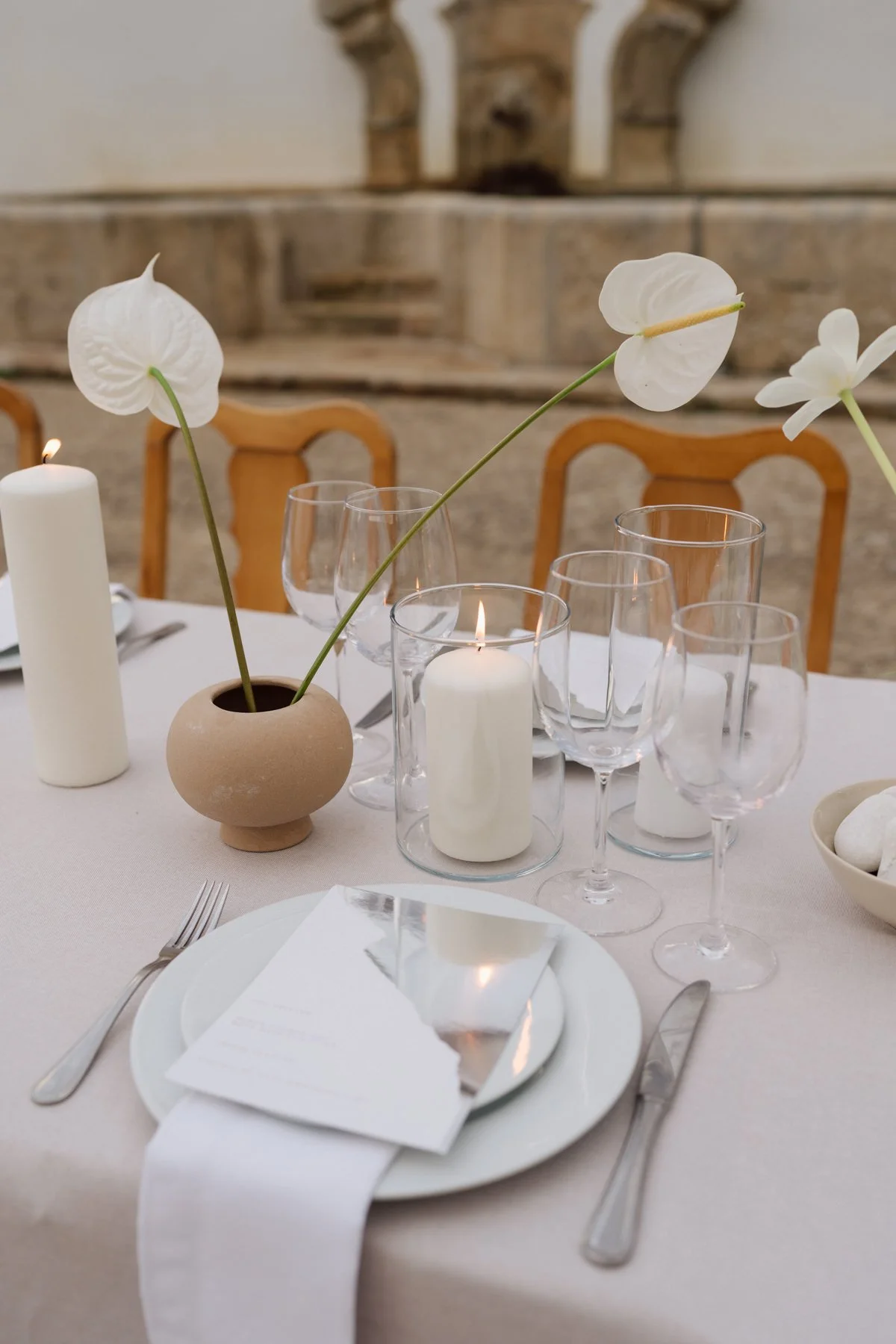Décoration de table minimaliste avec anthuriums blancs et bougies lors d’un mariage à la Quinta do Pinho au Portugal – réception élégante et raffinée