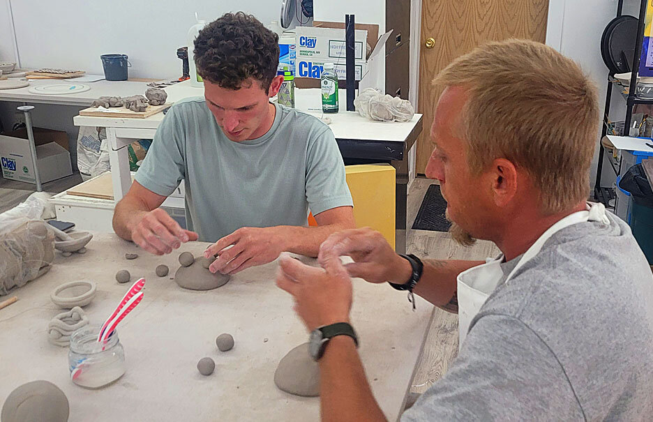   Blayze and one of the men from Matthew House working on clay sculpture.  