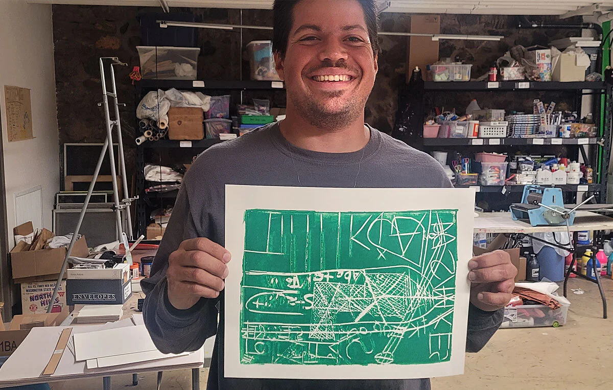 One of the men proudly displays his finished print.
