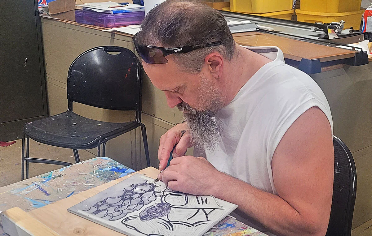 Cutting a linoleum block in the printmaking class.