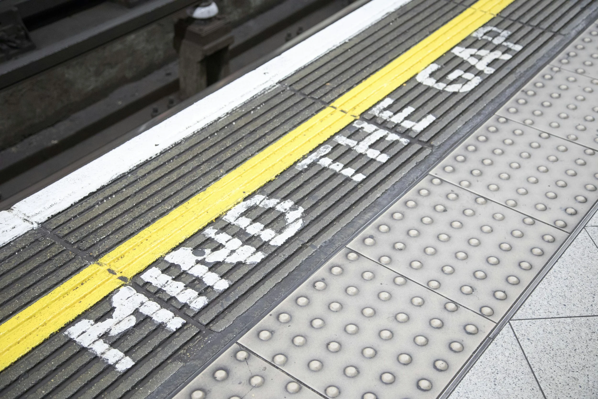 Mind the Gap" warning on a subway platform, symbolizing the gap between strategic plan and activation