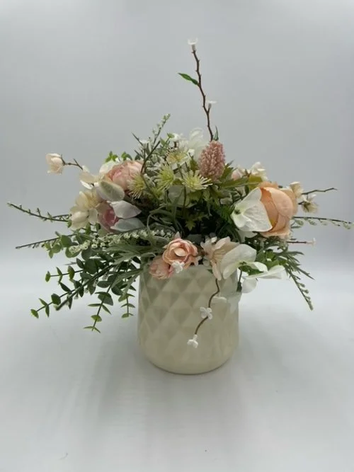 Faux Floral Arrangement in White Ceramic Vase
$12