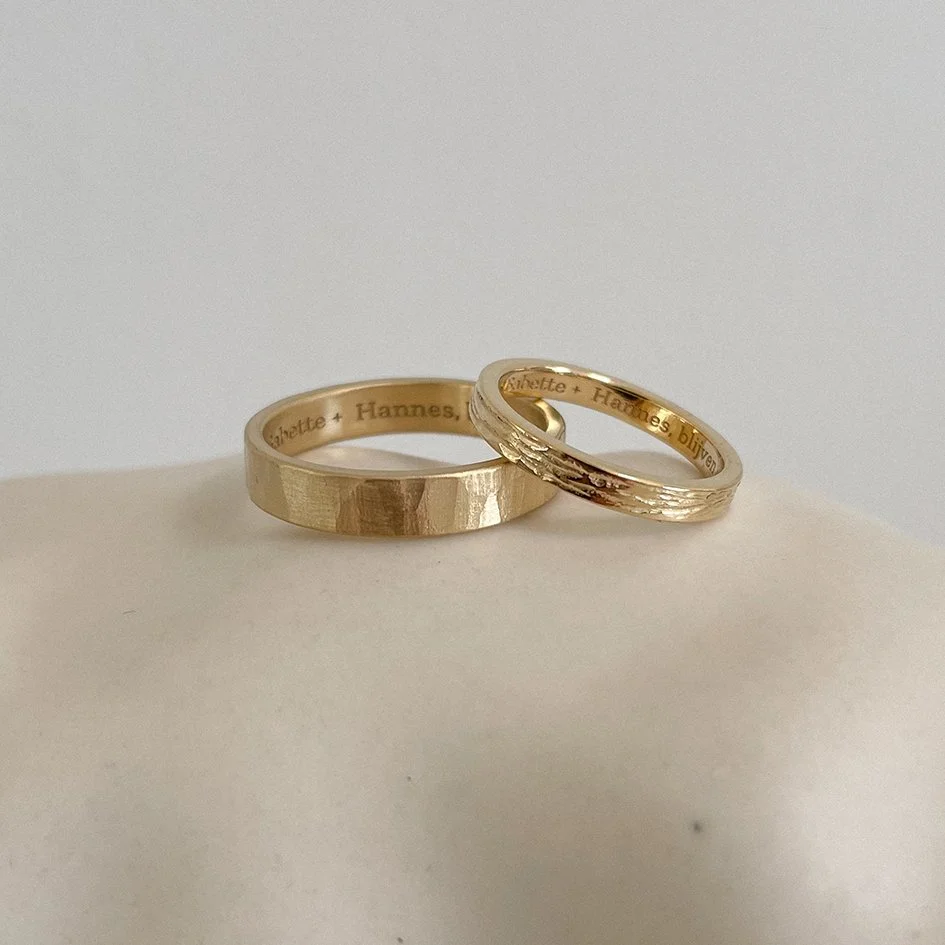 Wedding rings with a hammered and rough texture, crafted from 18k sustainable gold