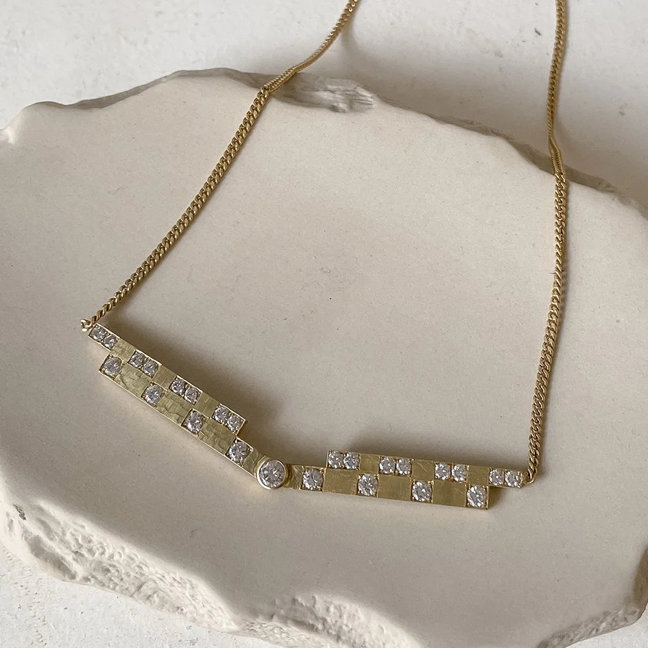 Diamonds from old family heirlooms were transformed into a contemporary necklace inspired by the Art Deco style