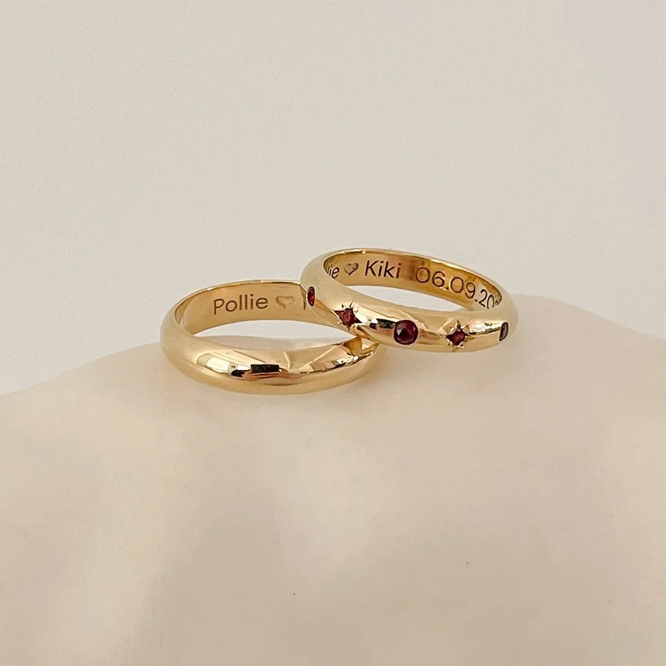 Classic wedding bands with a modern twist and red garnets for her