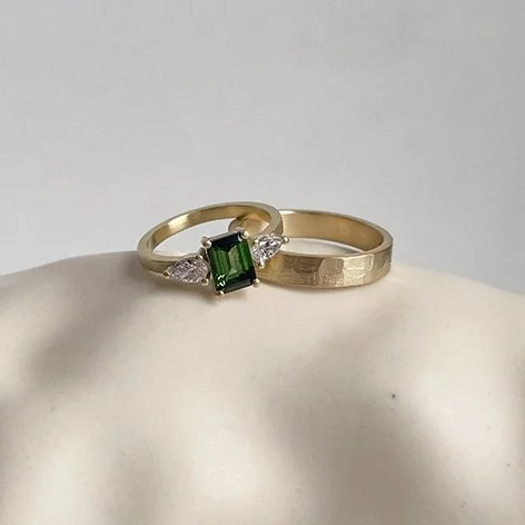 big statement wedding ring with gemstone and diamond and textured ringband for her and the same textured rigband for him