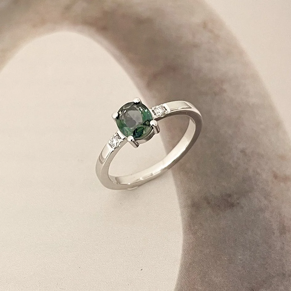 engagement ring in white gold with oval gemstone and 2 side diamonds, crafted by jeweller de vree 