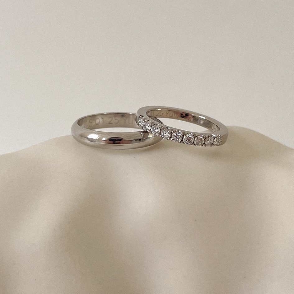Handcrafted white gold wedding bands for him and her, featuring a row of sustainable diamonds