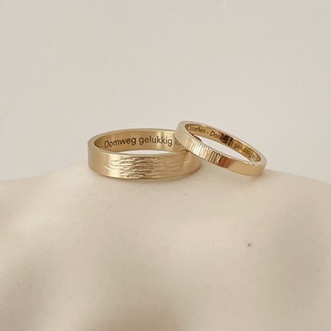Classic wedding bands with a twist: textured surface on top of both rings. Made in antwerp