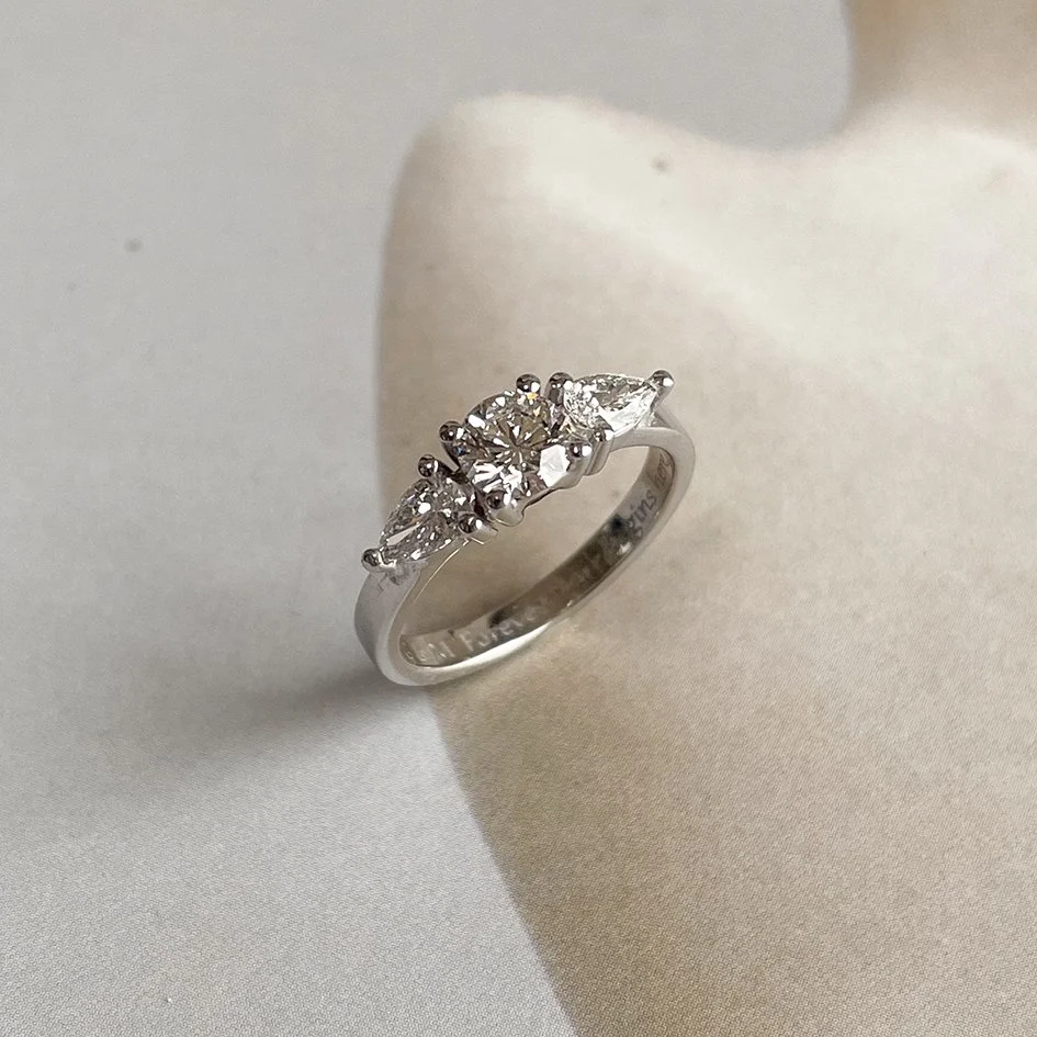 White gold engagement ring with a 0.5-carat diamond and accent diamonds. Ethically crafted in Antwerp by sustainable goldsmith De Vree