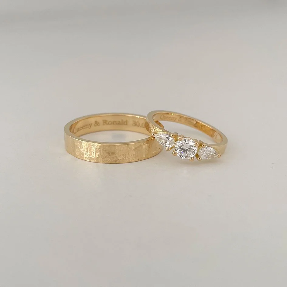 Men's wedding band with a subtle texture, women's wedding band with a subtle texture and large diamonds