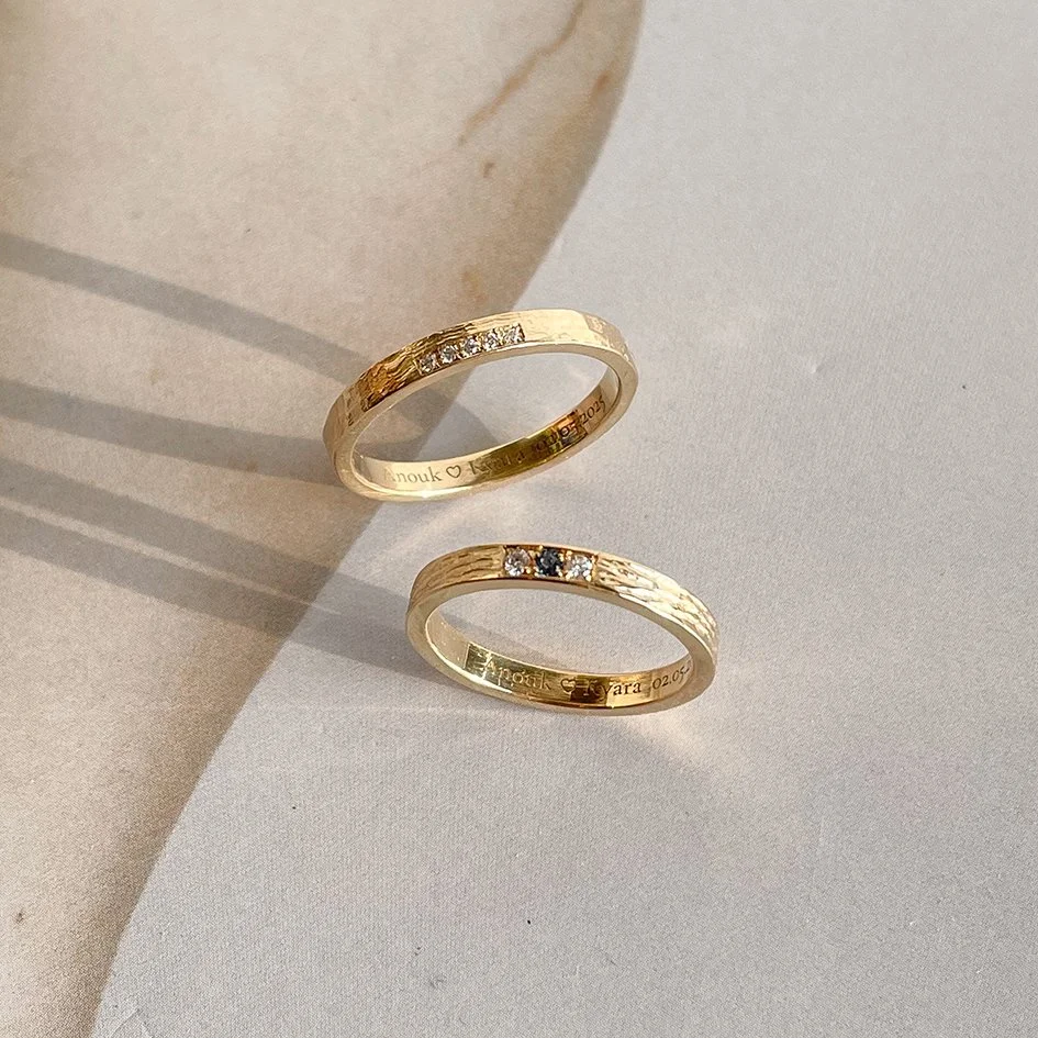 Textured wedding rings with small diamonds, made in Antwerp