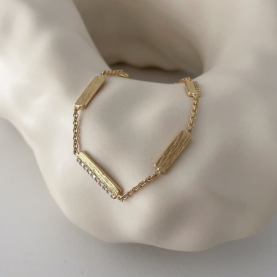 An organic, textured bracelet made from the client’s heirloom gold and diamonds.