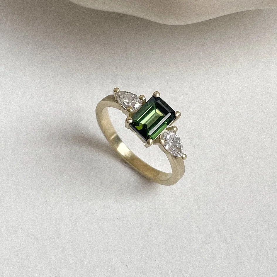 3 stone engagement ring, ethical engagement ring made in Antwerp with emerald cut center stone