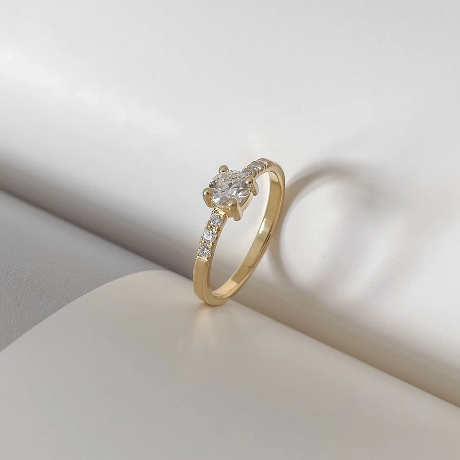 Solitaire diamond engagement ring with small diamonds in the ringband.  