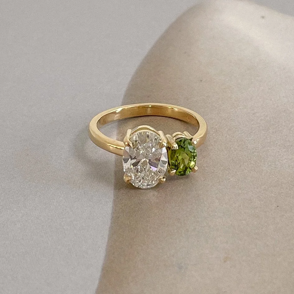 Moi & toi engagement ring with a gemstone and a large diamond, crafted from recycled gold by a sustainable goldsmith in Antwerp.