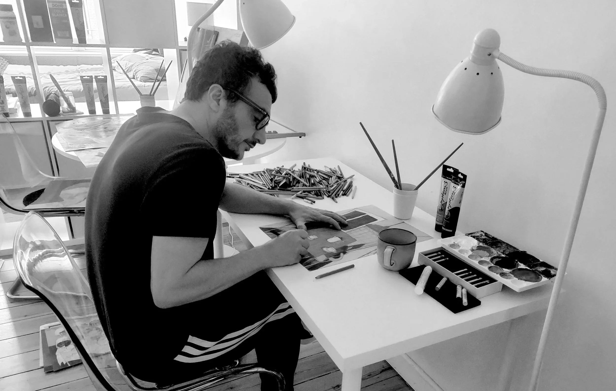 Alex Pascual creating a contemporary figurative coloured pencil drawing in his Copenhagen studio.