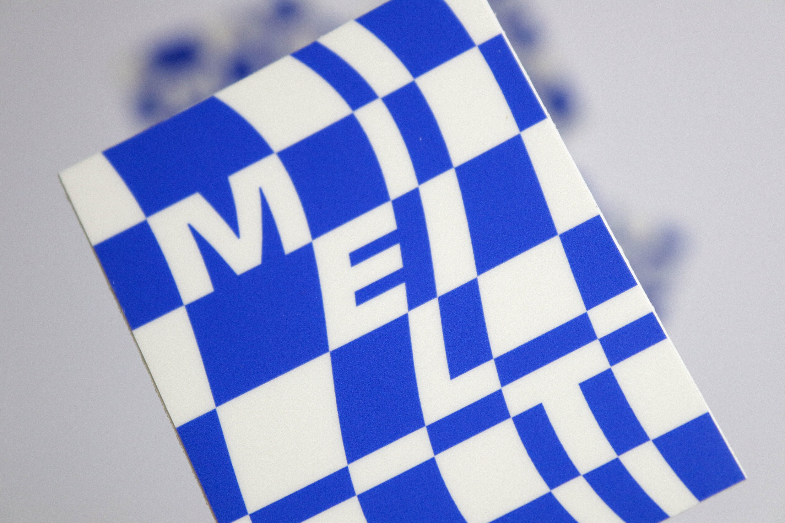 Vinyl sticker with custom “MELT” graphic (blue & off-white), 2” x 2.5”.