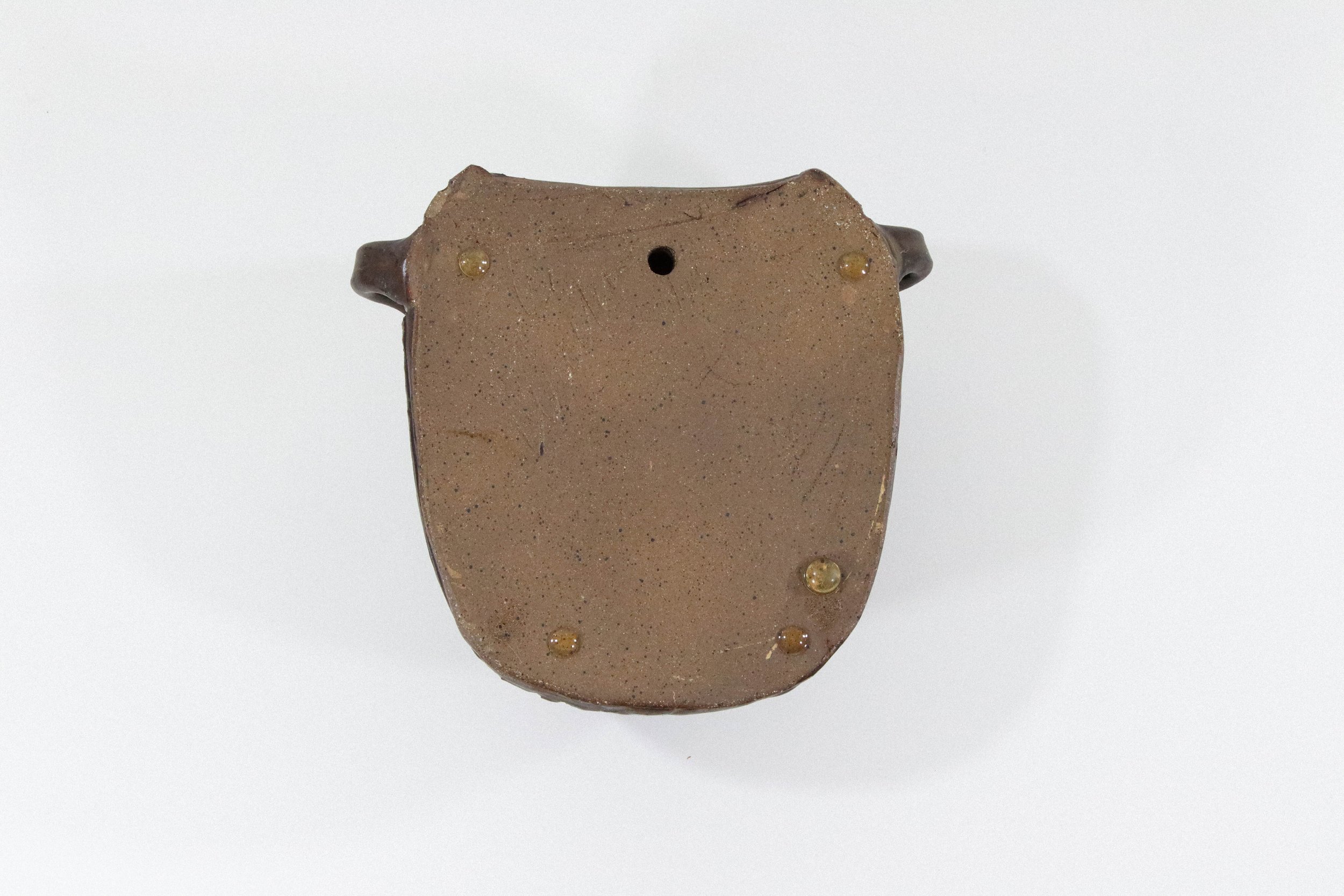 Handmade ceramic wall pottery vase with two side loops and one hole in the back for hanging. Signed and dated on the back by the artist Ed Walton in 2003.