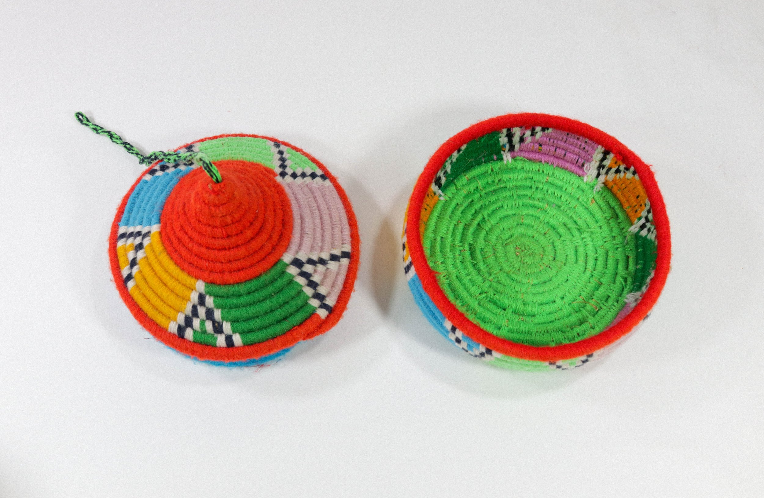 Hand-woven multicolor African hanging basket—a colorful storage solution for anywhere in the house! Lid stays on, even when basket is hung.