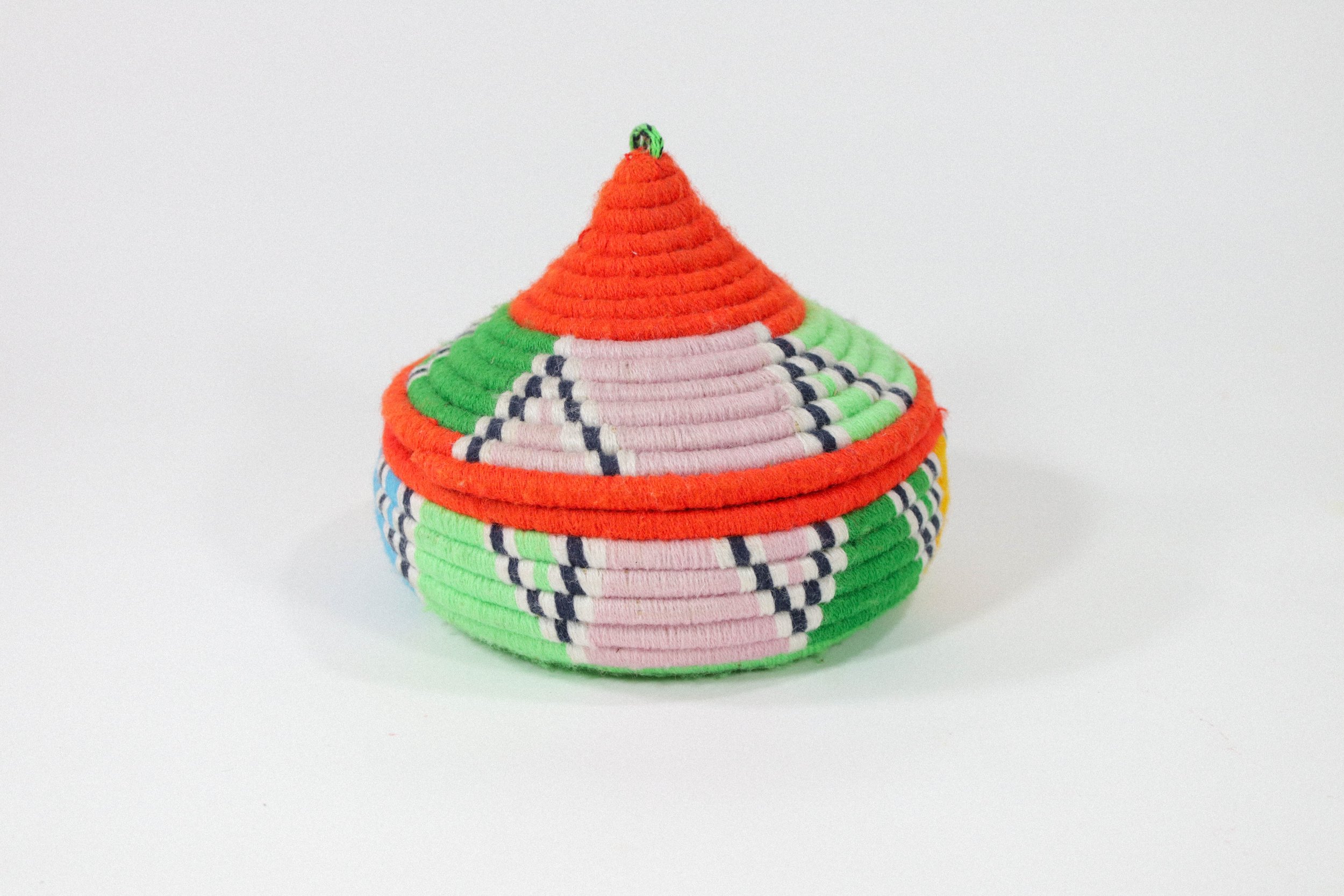 Hand-woven multicolor African hanging basket—a colorful storage solution for anywhere in the house! Lid stays on, even when basket is hung.