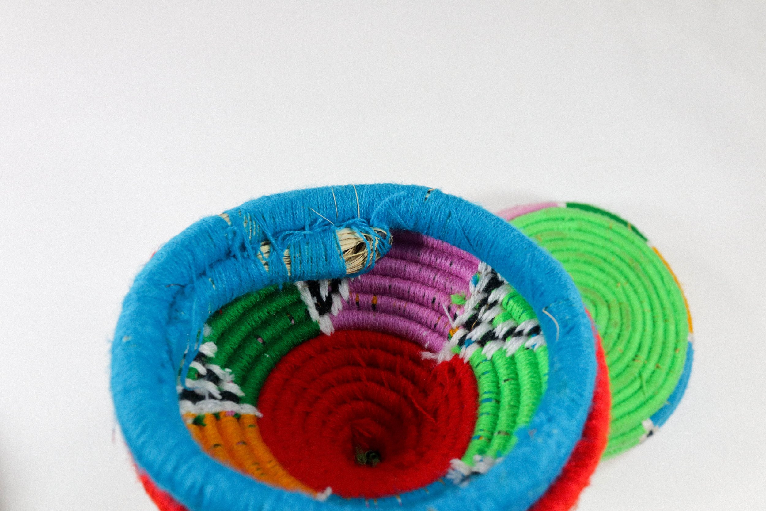 Hand-woven multicolor African hanging basket—a colorful storage solution for anywhere in the house! Lid stays on, even when basket is hung.