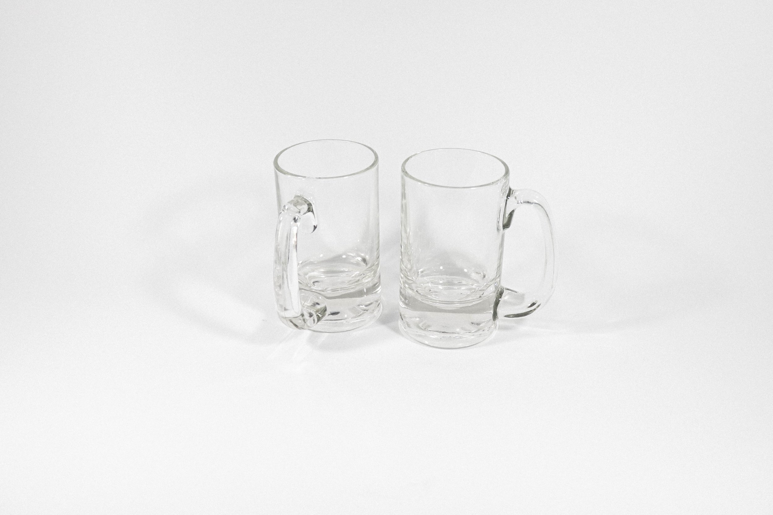 Set of two clear glass beer steins with a nice, weighty feel.
