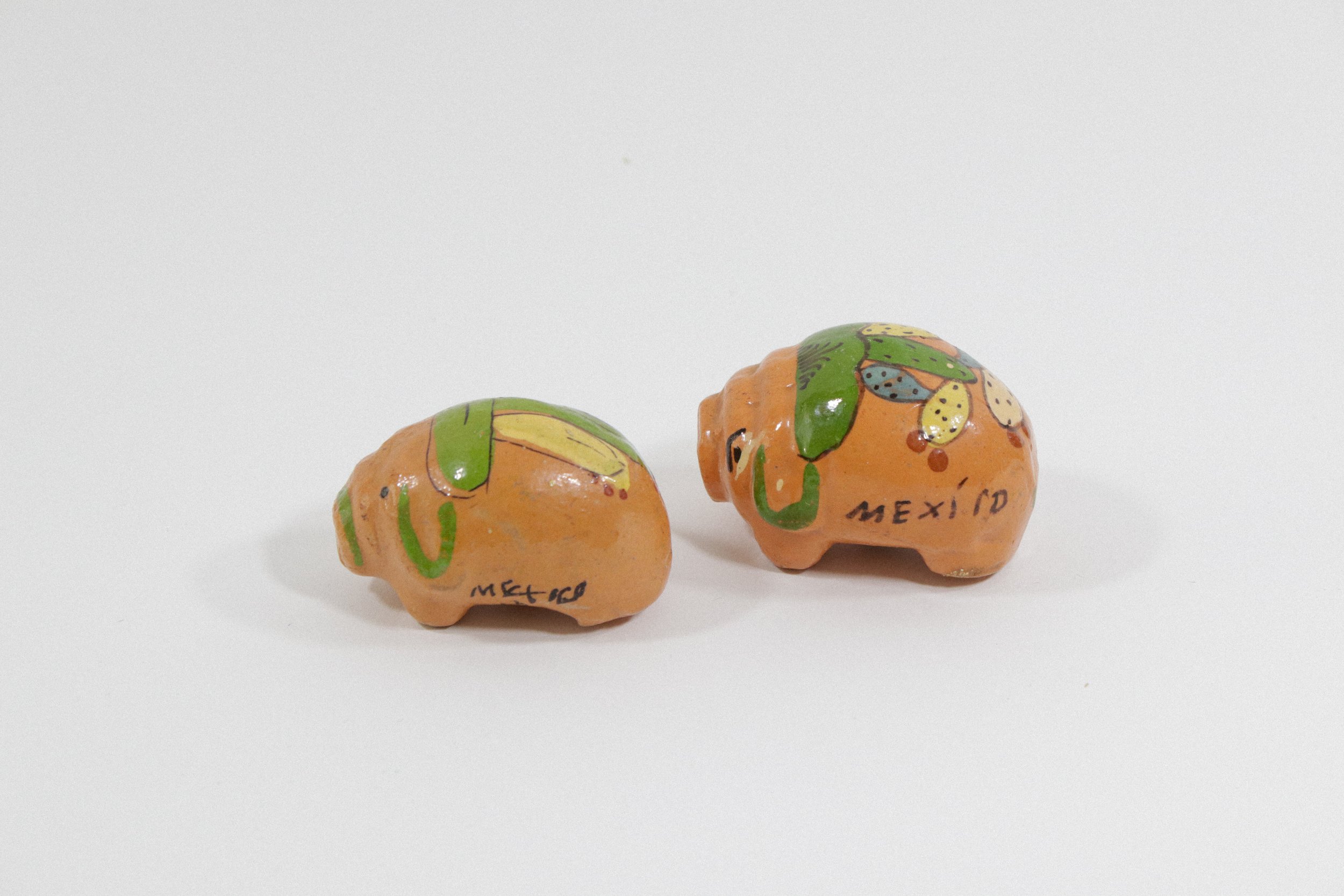 Set (2) of handpainted ceramic pig salt and pepper shakers. Made in Mexico.