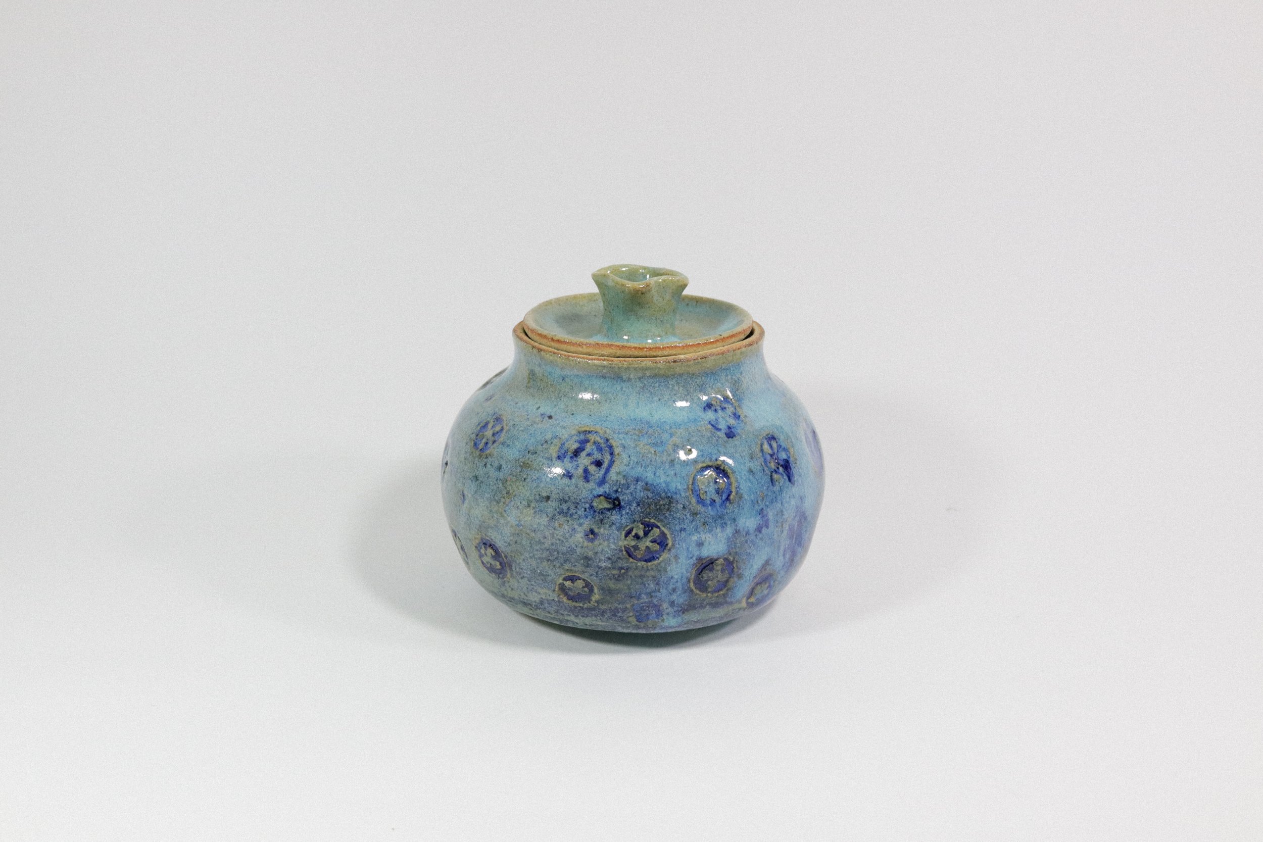 Handmade blue ceramic pottery jar with lid.