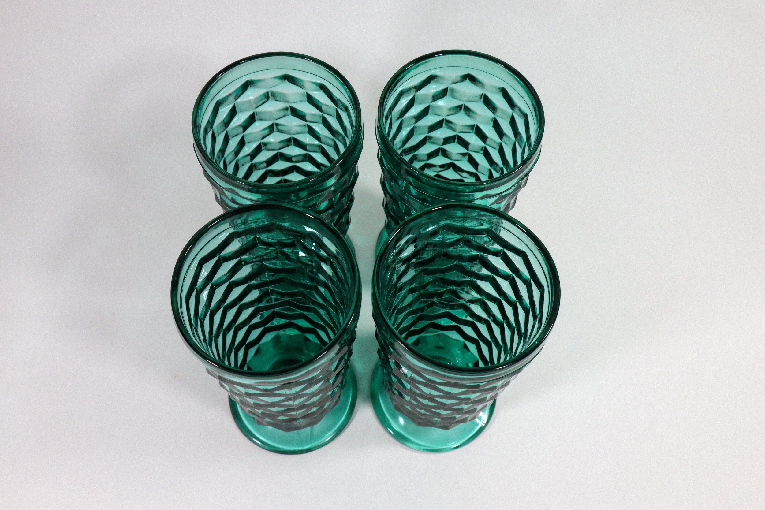 Set (4) of vintage, Indiana Whitehall cubist tall footed glasses in teal, a highly coveted colorway for this style of glassware.