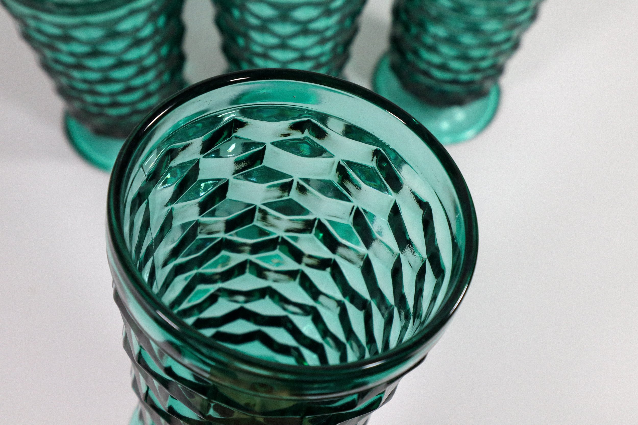 Set (4) of vintage, Indiana Whitehall cubist tall footed glasses in teal, a highly coveted colorway for this style of glassware.