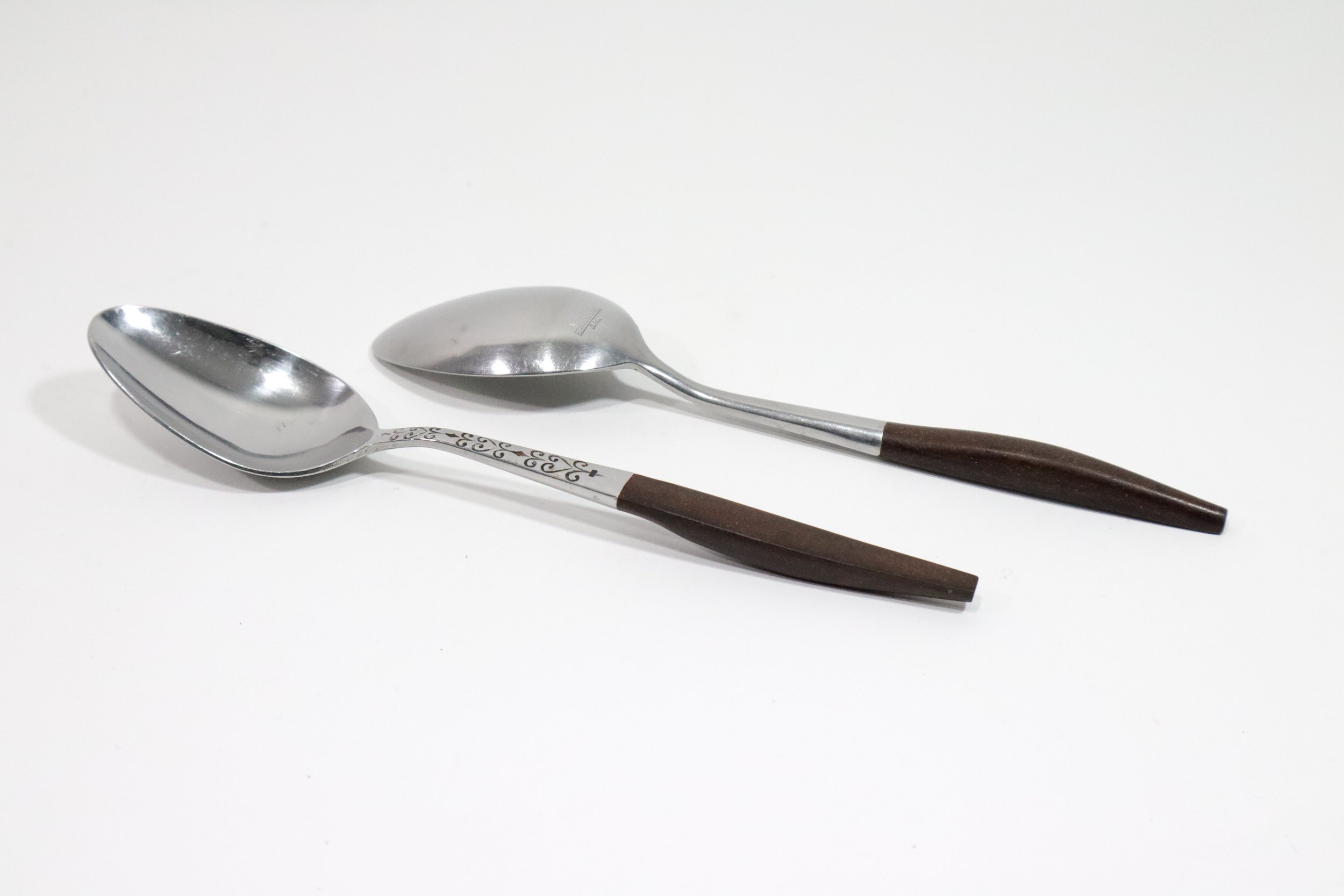 Vintage 1960s 36-piece Interpur Japan stainless steel and composite wood flatware set. Includes 8 dinner forks, 8 salad forks, 8 teaspoons, 2 tablespoons, and 10 knives.