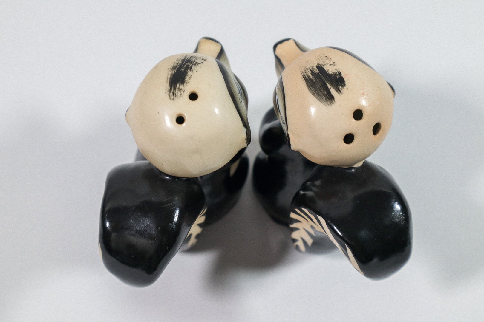 Set (2) of vintage German handpainted skunk salt and pepper shakers.
