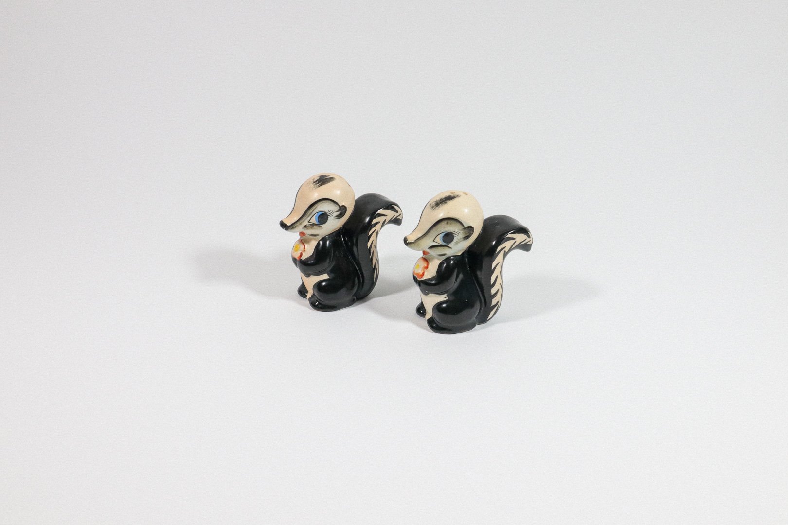 Set (2) of vintage German handpainted skunk salt and pepper shakers.