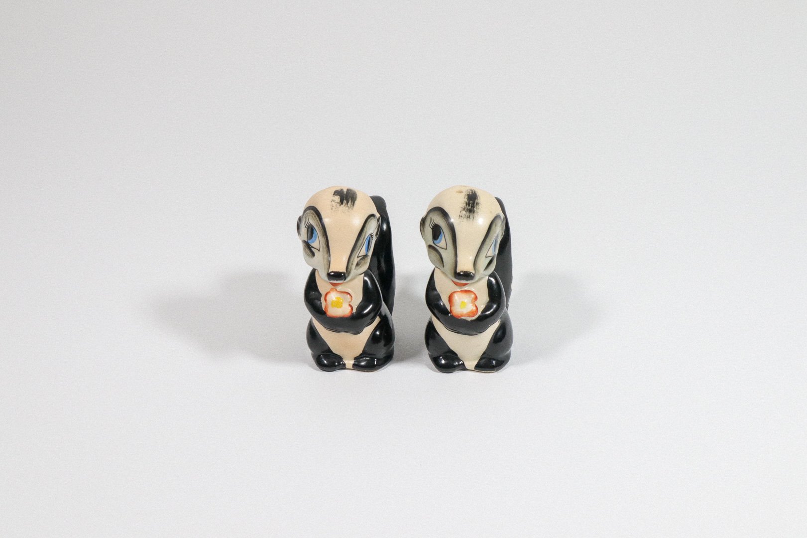 Set (2) of vintage German handpainted skunk salt and pepper shakers.