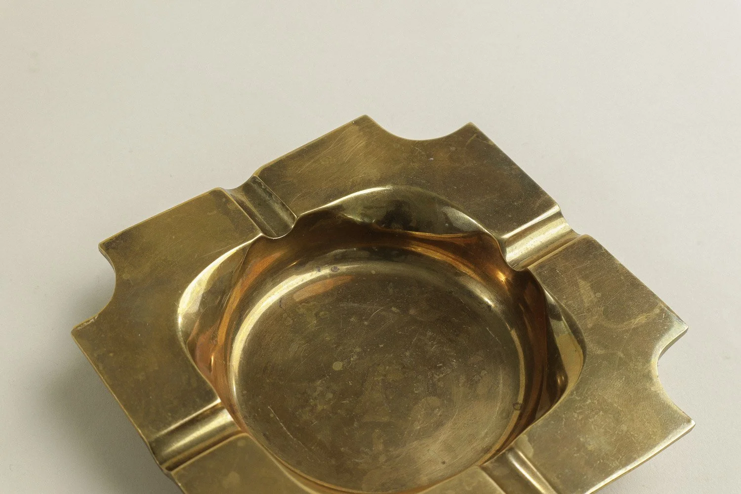 Vintage square solid brass ashtray with four notches. Weighty with a lovely natural patina.