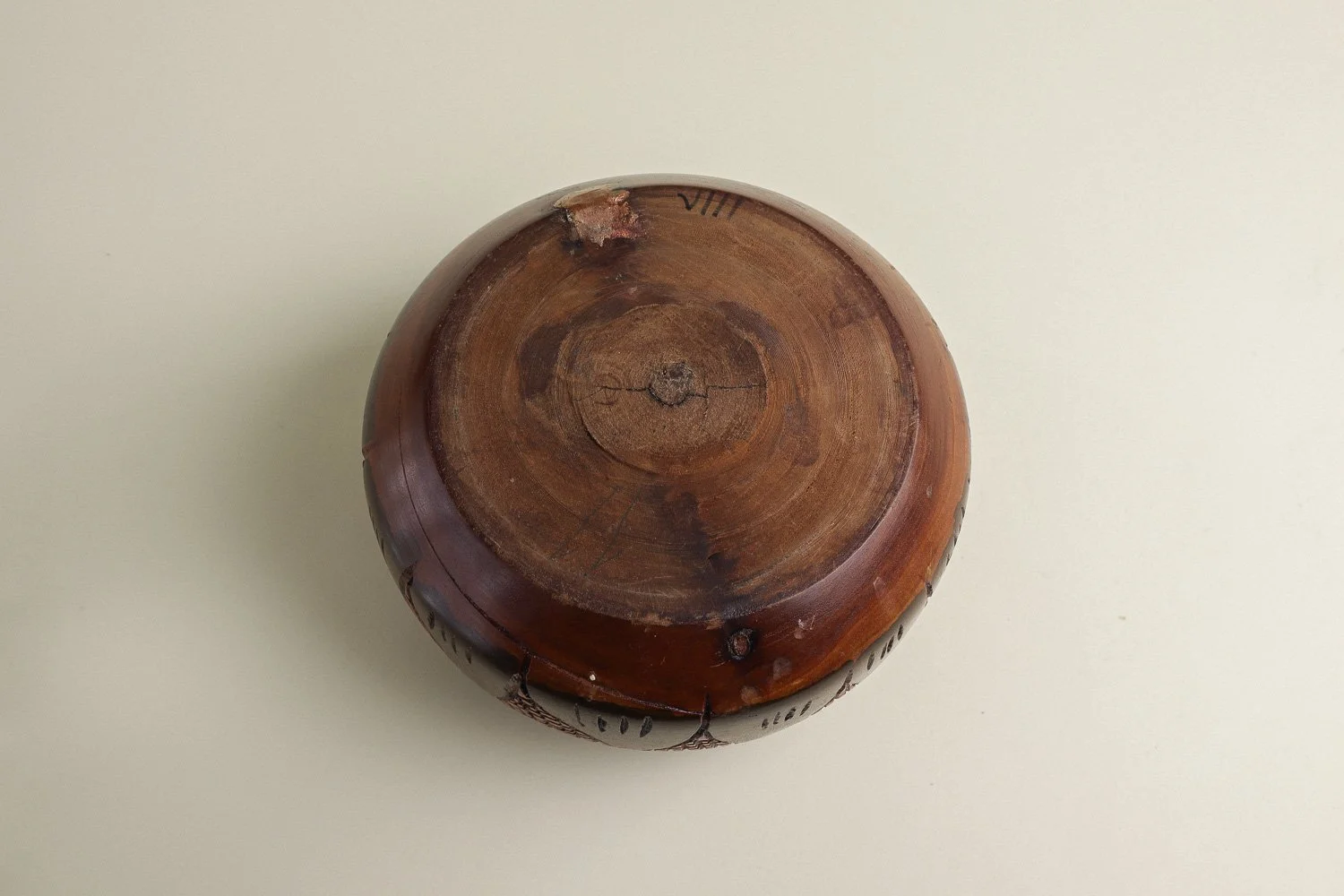 Handmade decorative wooden bowl featuring an intricate crosshatch and leaf pattern.