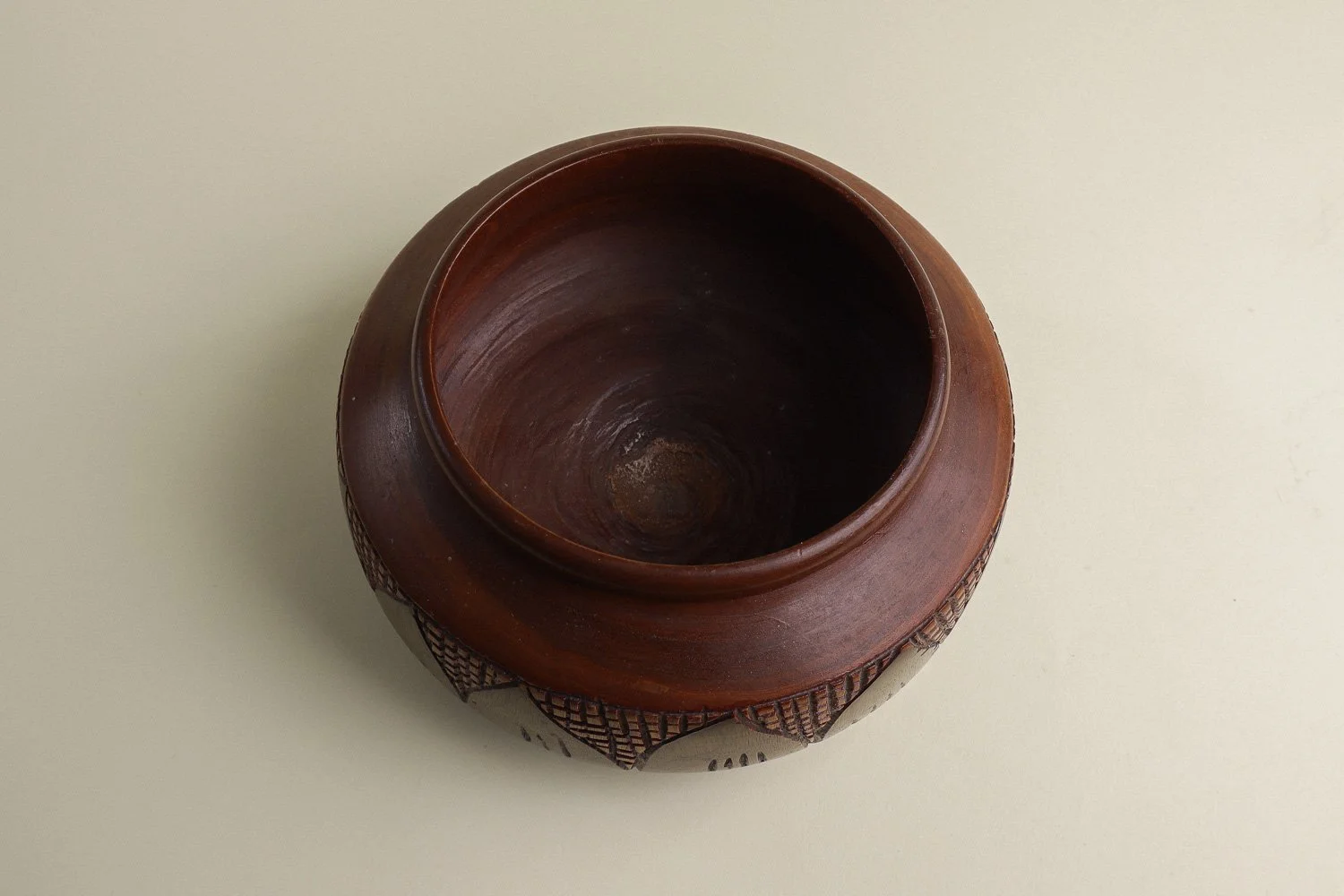 Handmade decorative wooden bowl featuring an intricate crosshatch and leaf pattern.