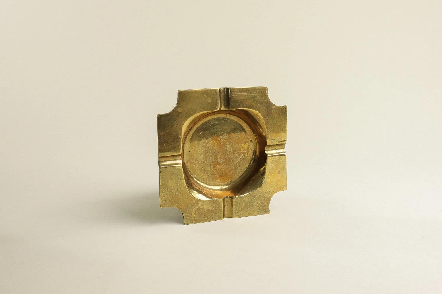 Vintage square solid brass ashtray with four notches. Weighty with a lovely natural patina.