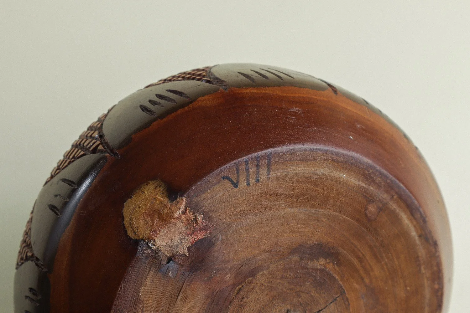 Handmade decorative wooden bowl featuring an intricate crosshatch and leaf pattern.