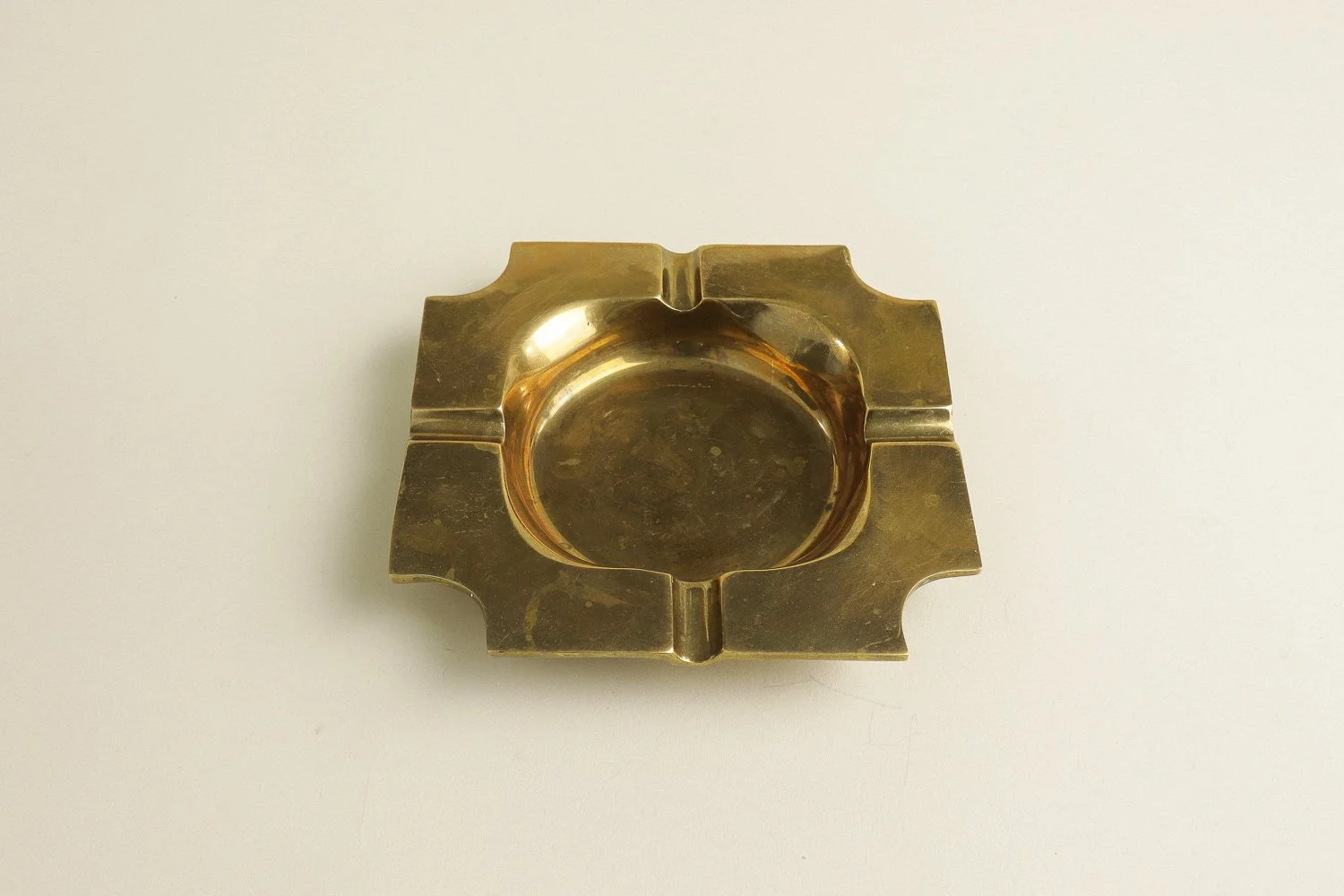 Vintage square solid brass ashtray with four notches. Weighty with a lovely natural patina.
