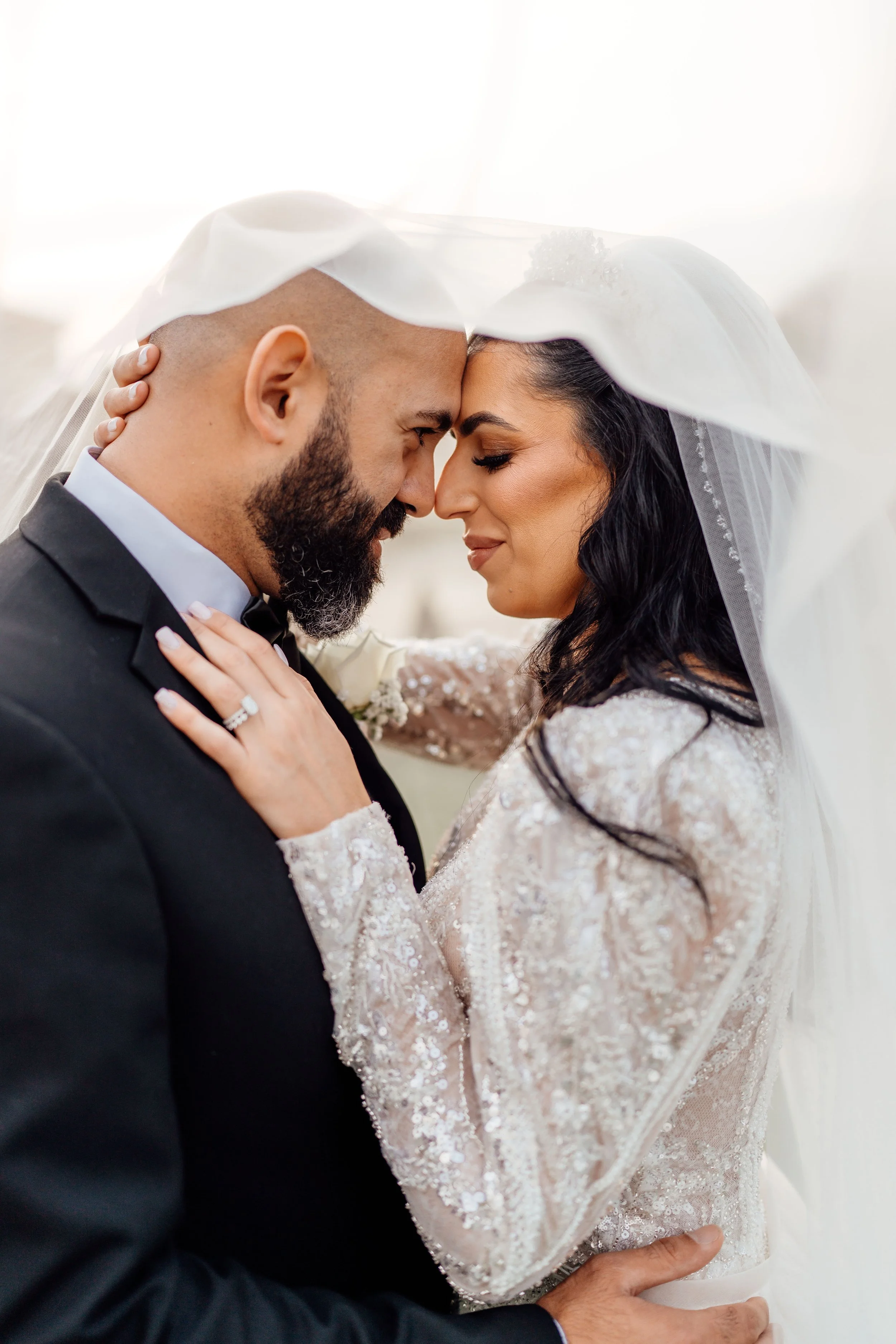 Newlyweds sharing a quiet moment beneath the veil