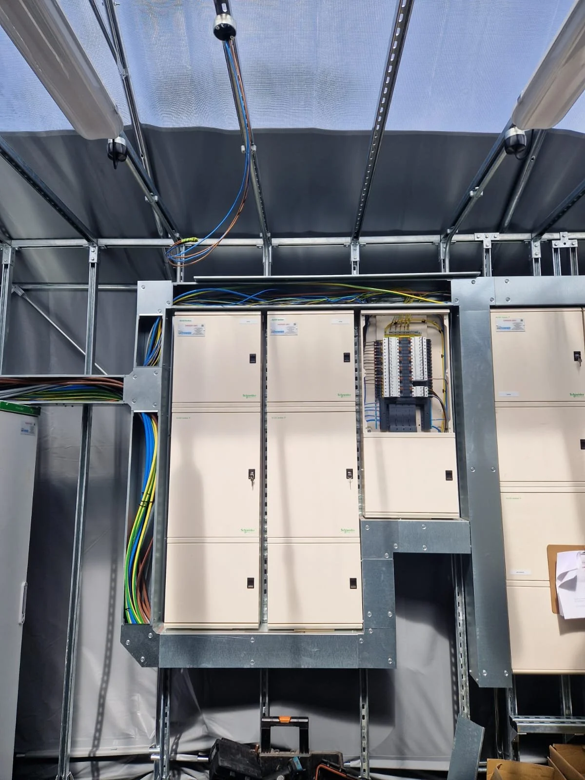 Electrical cabinets and wiring inside a construction site or industrial setting.