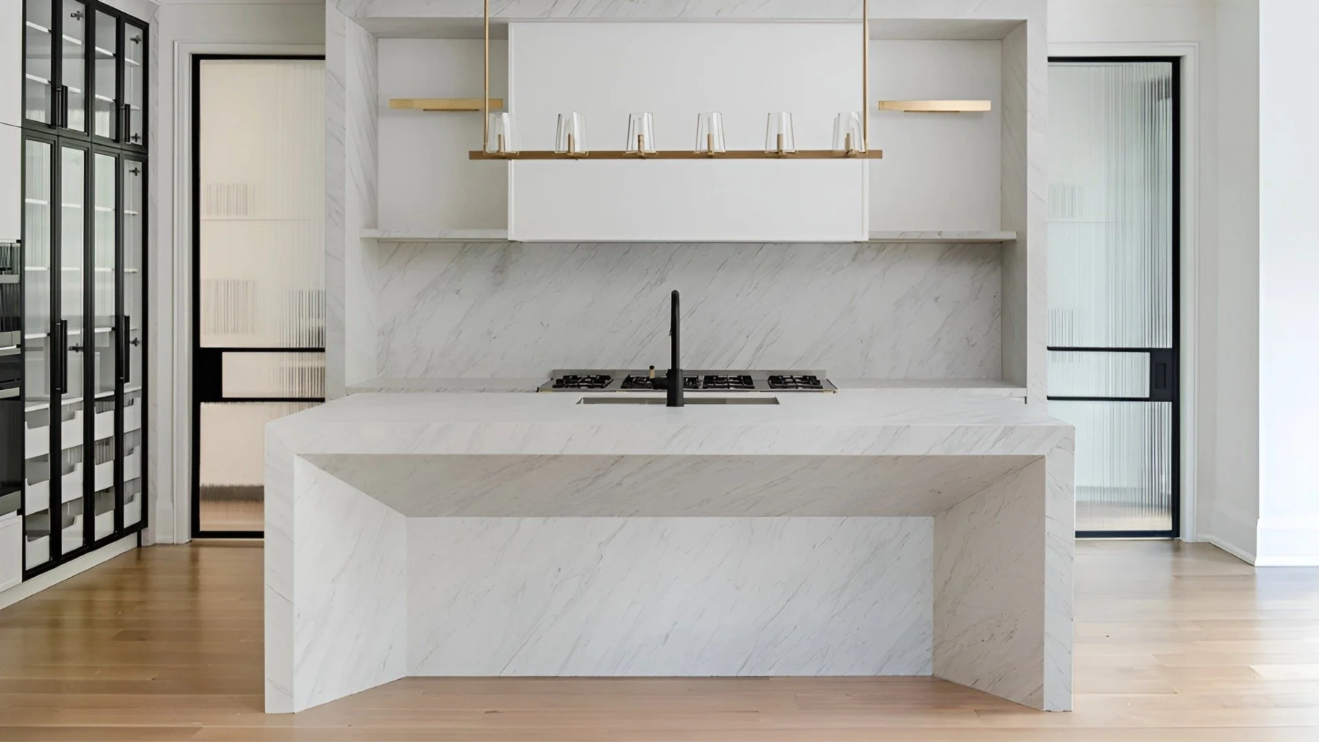 PARVIZ chef's kitchen in Forest Hill Toronto with integrated cabinetry, black-framed glass storage, and stone surfaces.