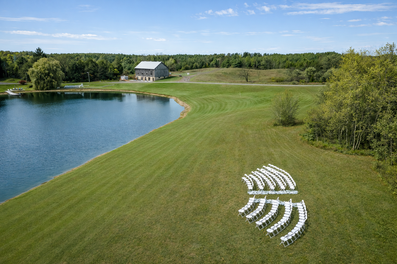 A serene outdoor wedding ceremony site at The Hummingbird in Erin, Ontario, overlooking a private pond and rolling countryside. The open landscape allows for flexible ceremony layouts and breathtaking views in every season.
