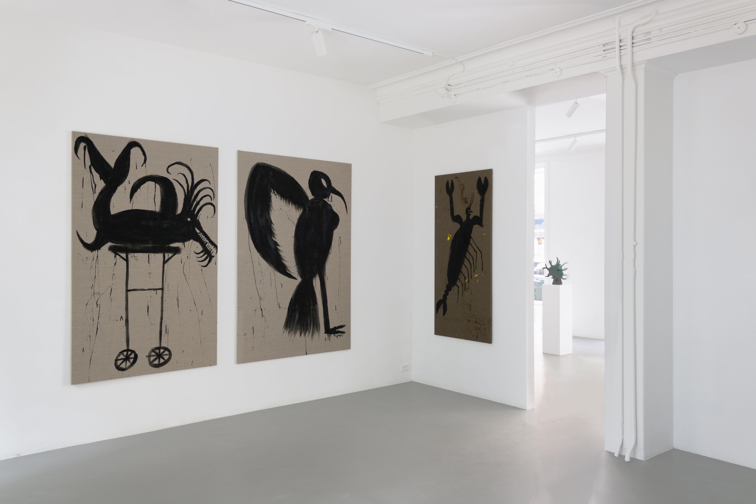 Contemporary art gallery with four large paintings of abstract black creatures on beige backgrounds, displayed on white walls. Frederik Næblerød exhibition at Alice Folker Gallery. 